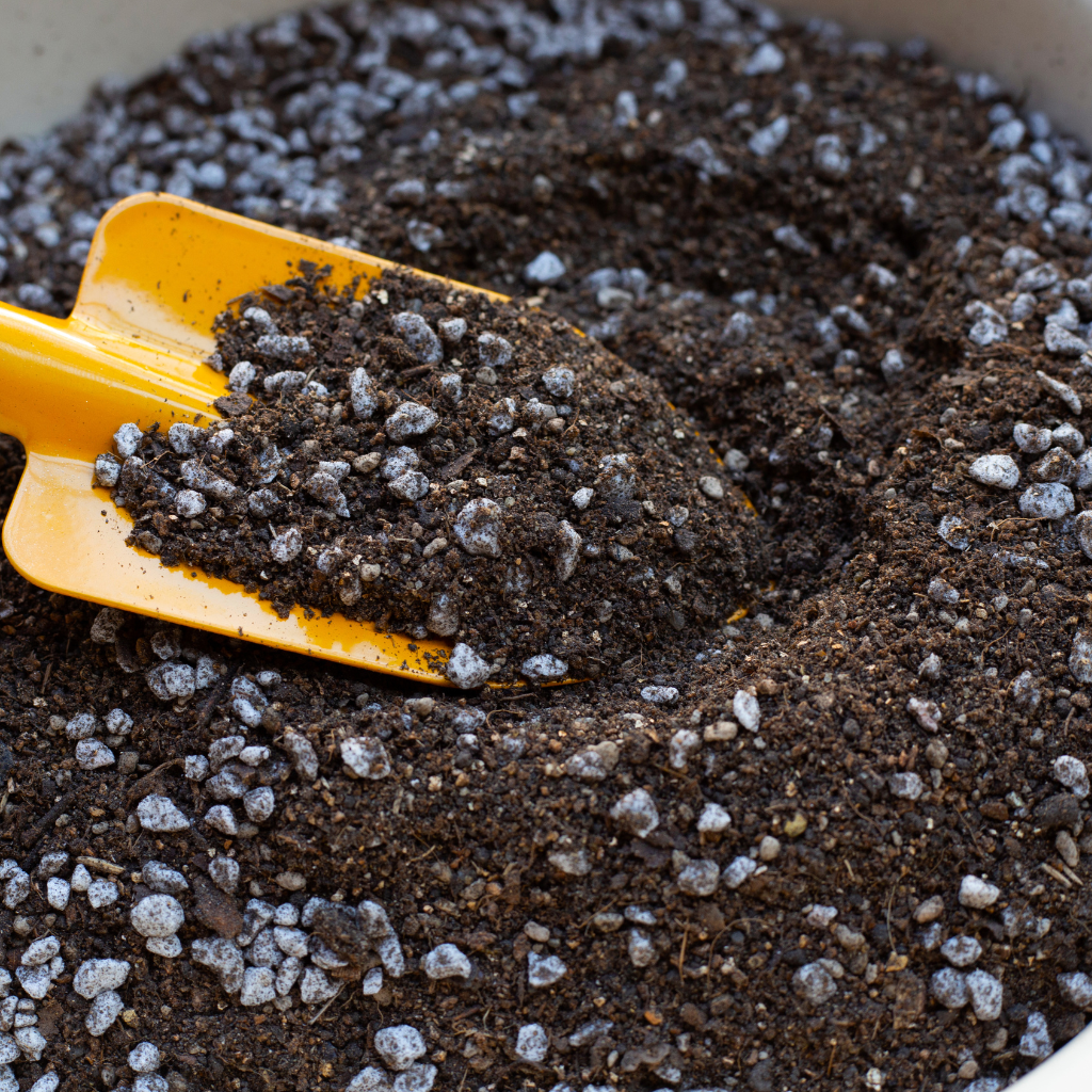 Potting mix with perlite and yellow garden scoop