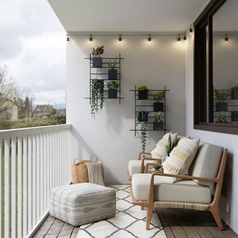 Cozy balcony with wooden chairs, footrest, and hanging green planters on the wall