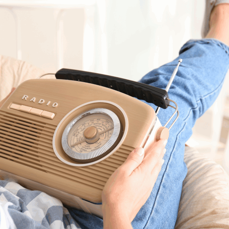Person holding a vintage radio while lounging