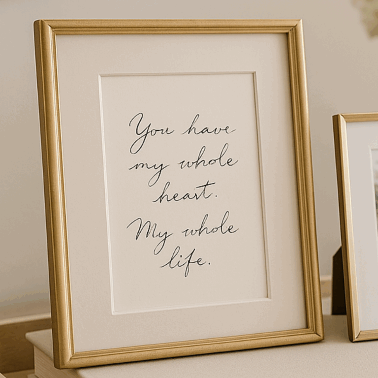 Gold-framed wall art with handwritten text that reads, “You have my whole heart. My whole life.”