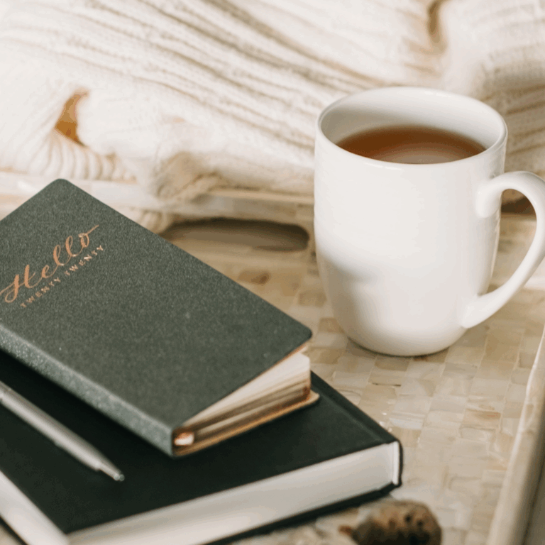 Morning journaling setup with notebooks and tea