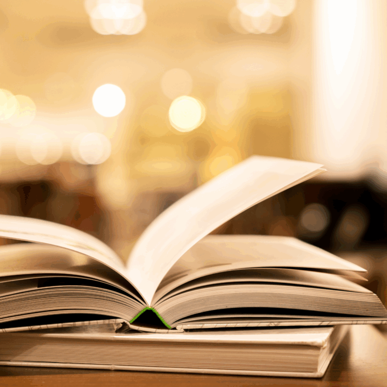 Open book with blurred warm lights in the background
