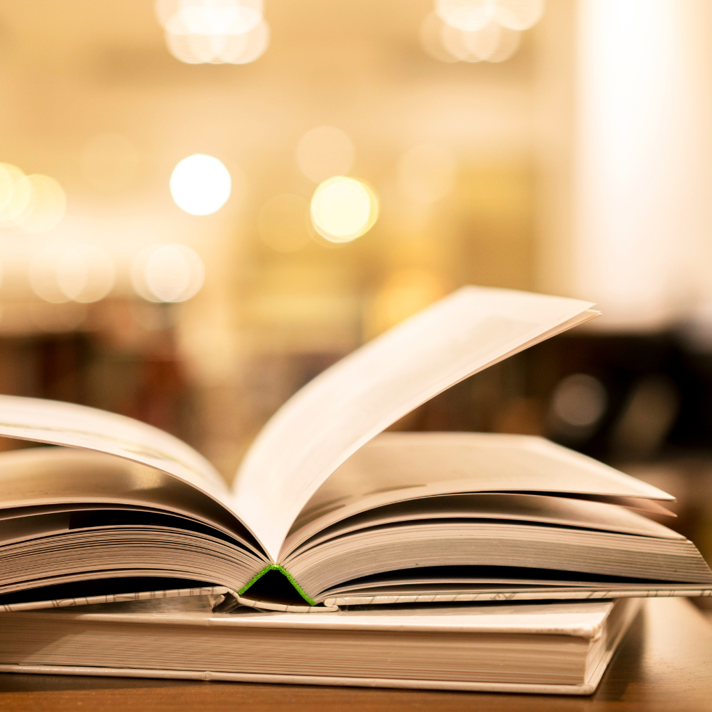 Open book with blurred warm lights in the background