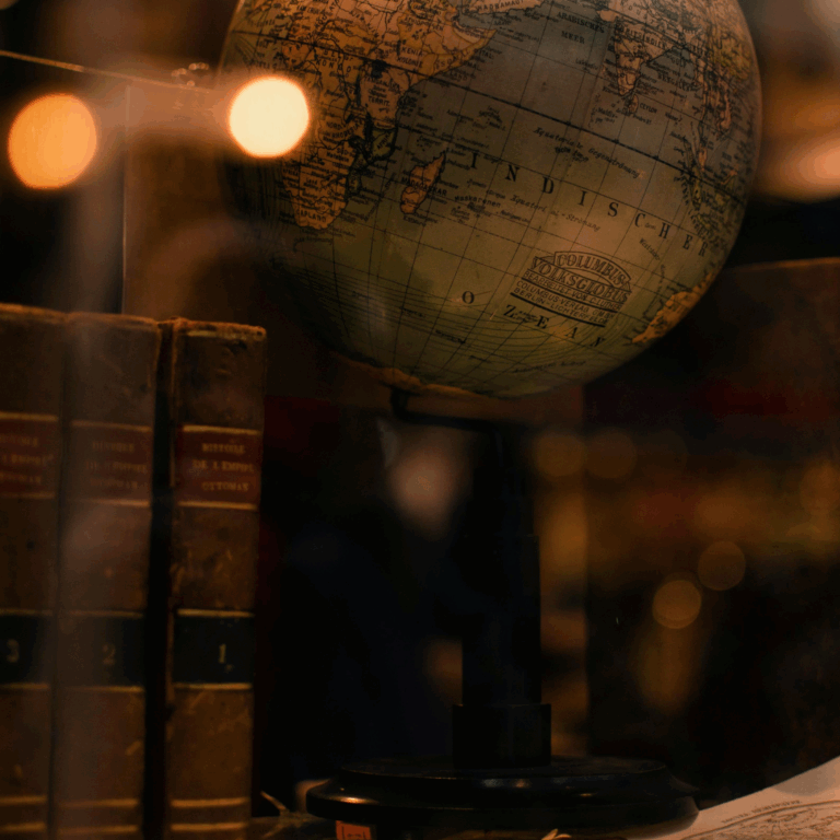 Vintage globe with antique books in warm lighting