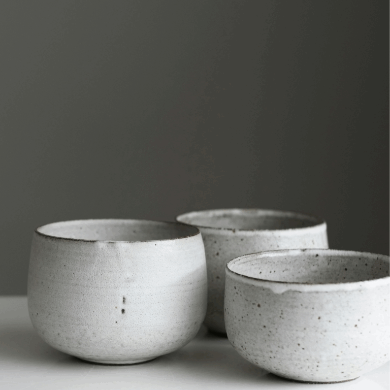 Minimalist white handmade ceramic bowls in wabi-sabi style