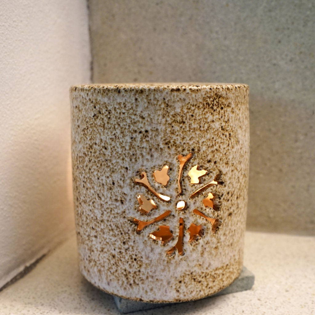 Rustic speckled ceramic candle warmer with floral cutout