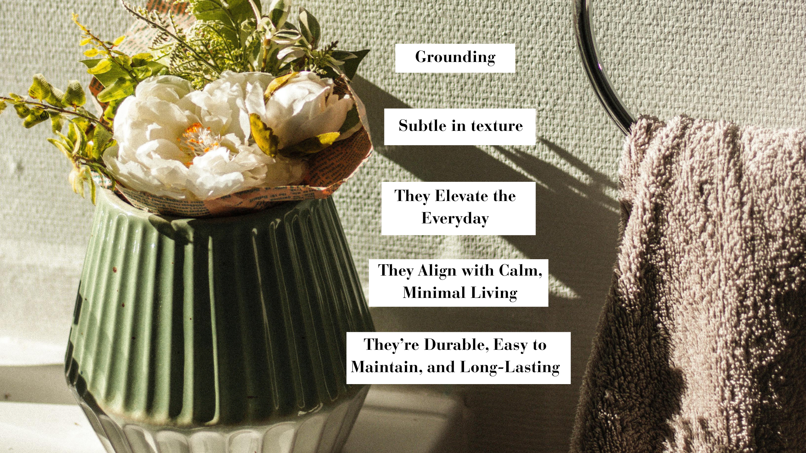 Green ceramic vase with white flowers on a bathroom sink beside a taupe towel, with text highlighting the benefits of the decor.
