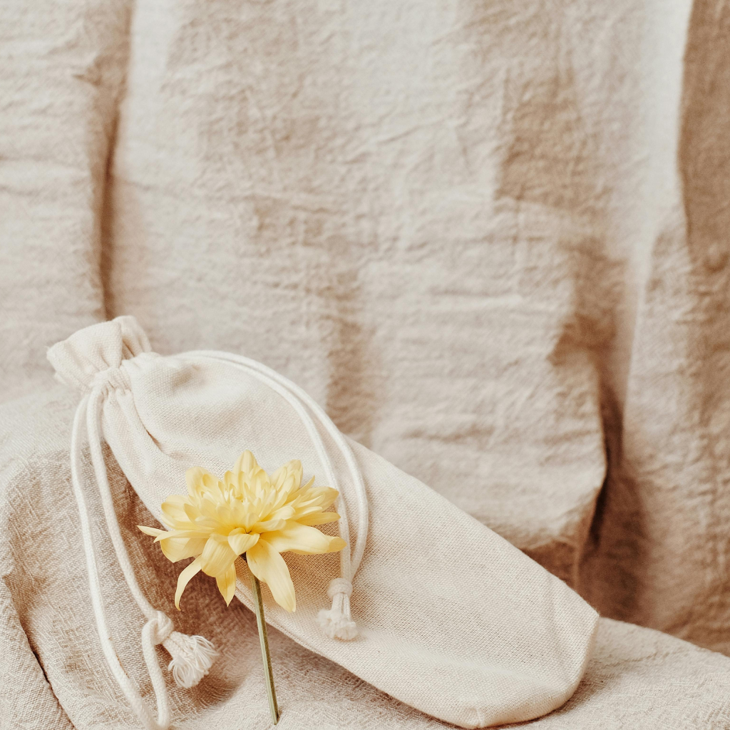 A fabric pouch with earplugs, eye mask, and essential oil roller