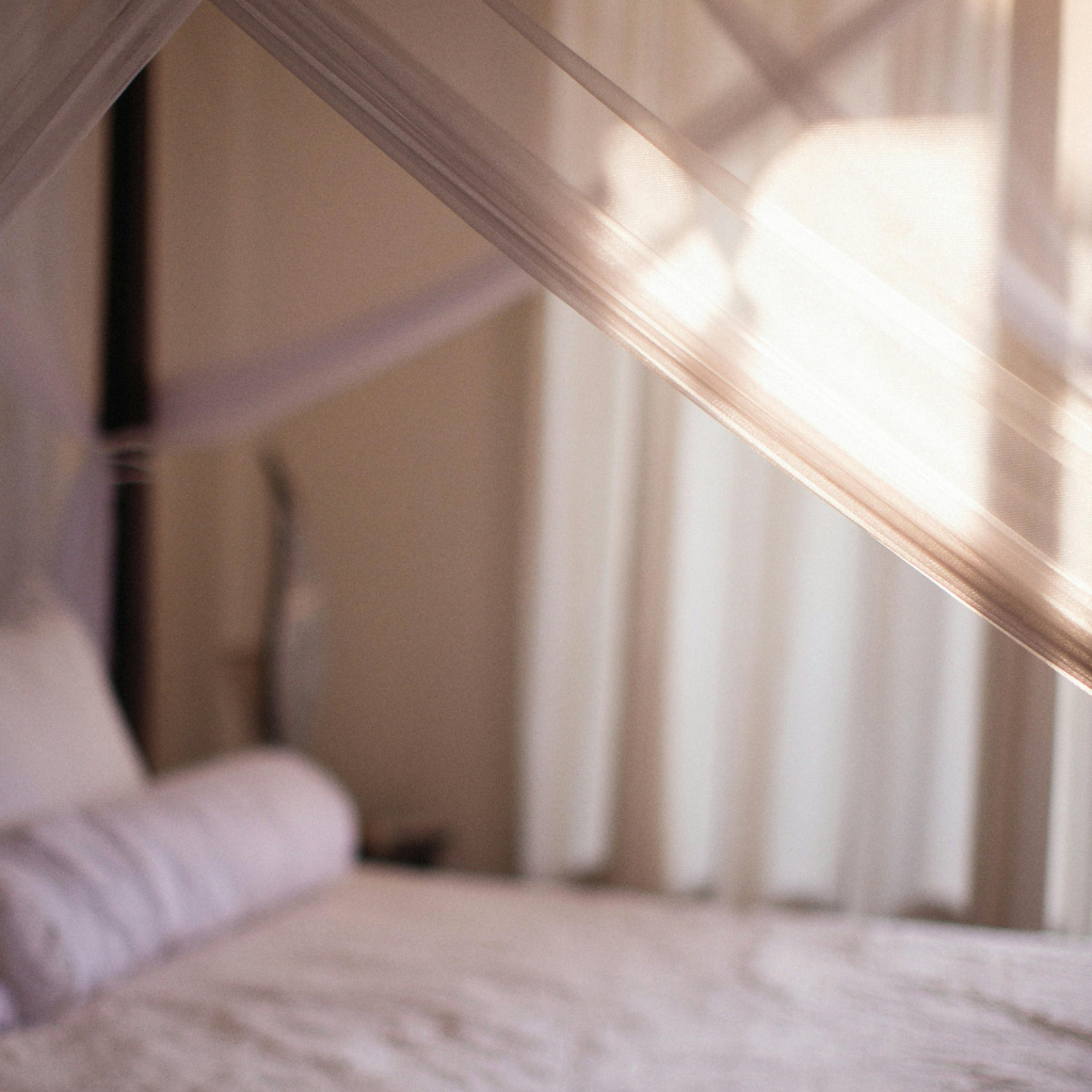 A flowing linen canopy clipped above your bed