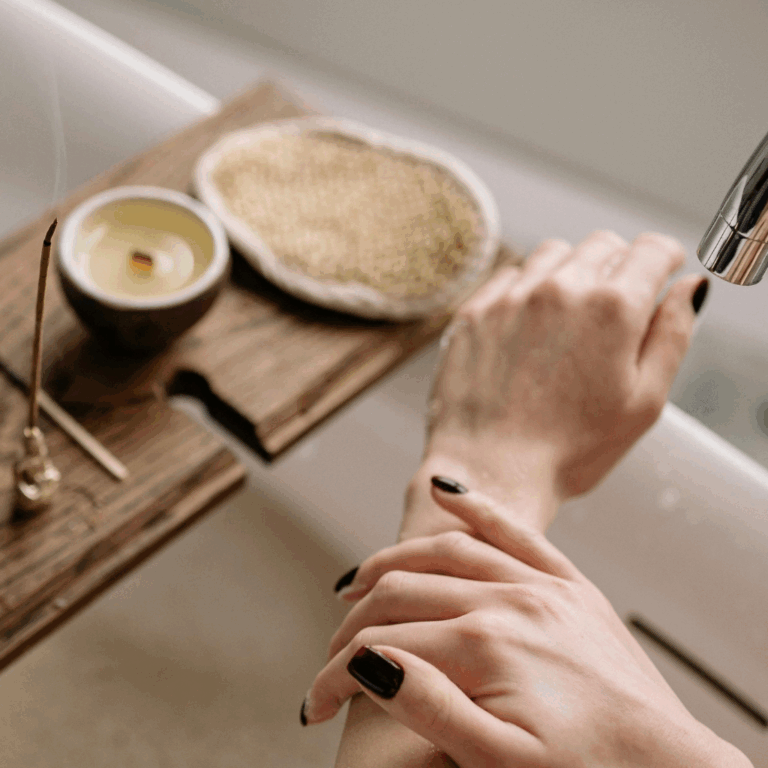 Relaxing bath setup with incense, candle, and exfoliating scrub on wooden bath tray