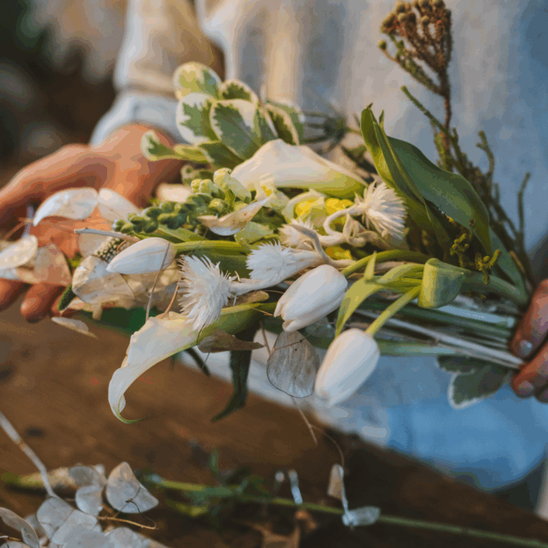 Woman holding a wildflower bouquet with white tulips