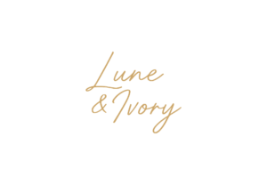 Lune & Ivory handwritten gold logo on a black background